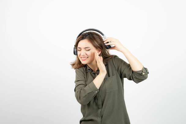 Image of young attractive woman in headphones listening to song. High quality photo - Fotoğraf, Görsel