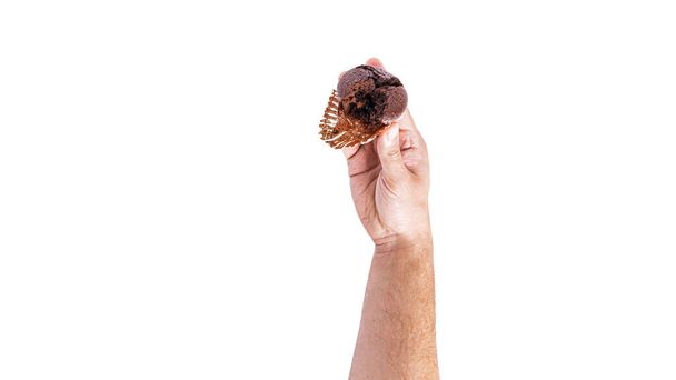 Chocolate cupcakes with cherry jam isolated on a white background. Chocolate muffin in hand. - Фото, зображення