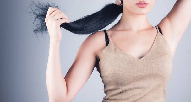 young woman straightens her hair with her hands - Photo, image