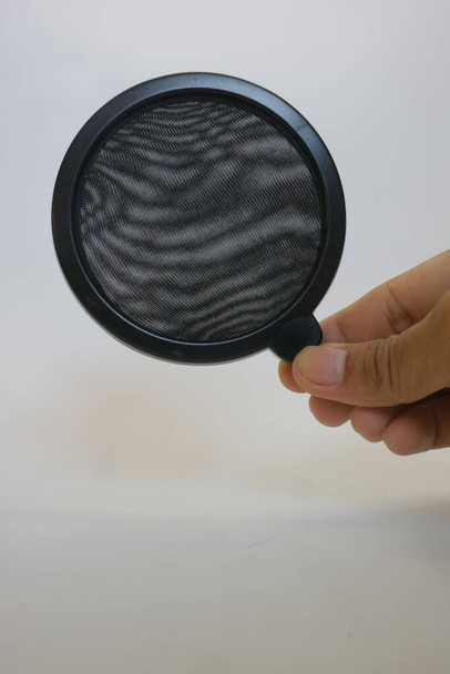 Black color of microphone pop filter on white isolated background photo - Photo, Image