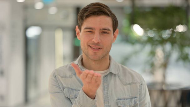 Portrait of Young Man giving Flying Kiss  - Foto, afbeelding