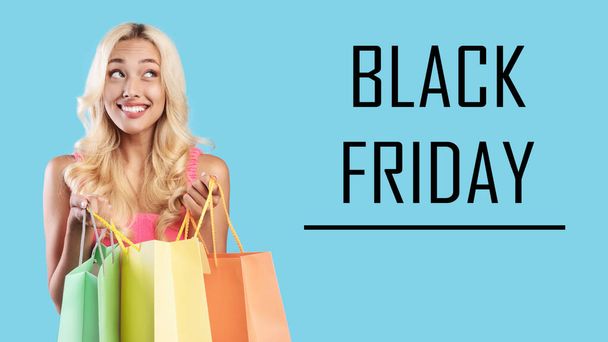 Black Friday. Excited woman holding colorful shopping bags - Photo, Image