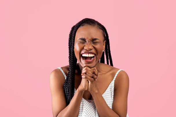 Excited black woman anticipating something wonderful, making wish, begging or praying over pink background - Foto, immagini