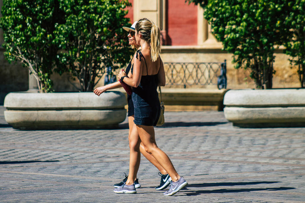 Seville Spain August 28, 2021 Pedestrian walking in the streets of Seville during the coronavirus outbreak hitting Spain, wearing a mask is not mandatory but most of people wear it - 写真・画像