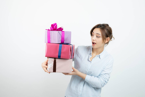 Portrait of a young cute girl holding present box with ribbon. High quality photo - Foto, Imagem