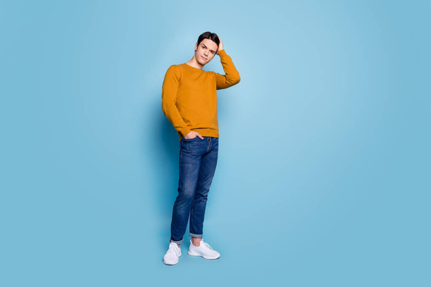 Photo of beautiful barbershop client guy touch hairdo wear orange shirt jeans footwear isolated blue color background - Φωτογραφία, εικόνα