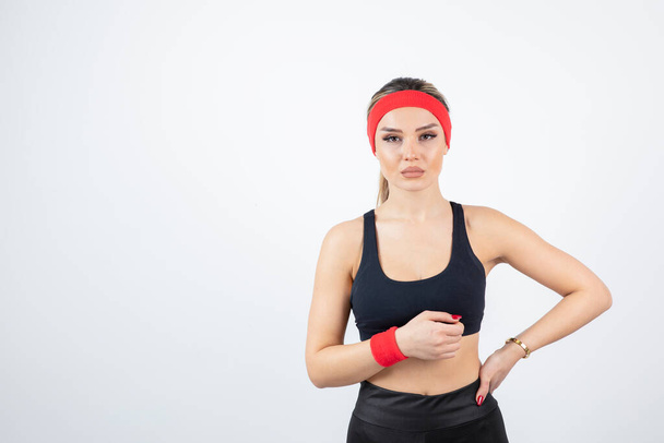 young woman in sportswear with a ball on a white background - Foto, Imagem