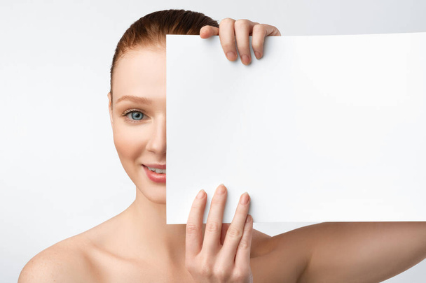 Young Female Holding Paper Covering Half Of Face, White Background - Photo, Image
