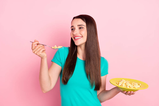 Profile side photo of young woman happy positive smile eat meal yummy tasty food cornflakes crisp isolated over pink color background - Valokuva, kuva