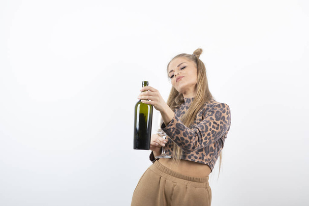 Photo of young attractive woman model holding wine bottle and glass . High quality photo - Photo, Image