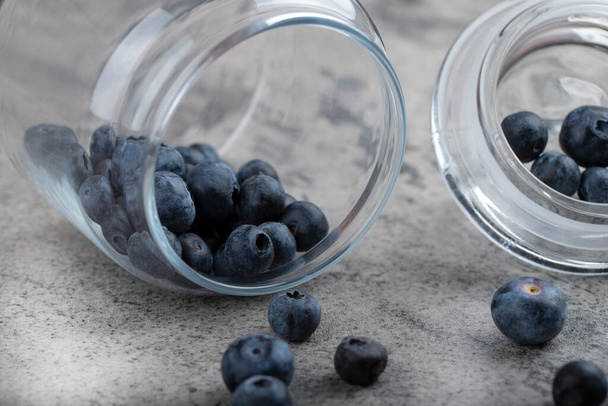 Glass jar full of fresh blueberries on stone background. High quality photo - Photo, Image