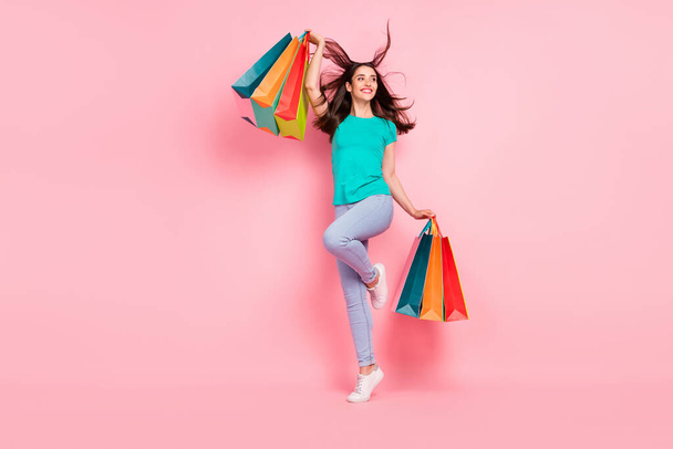 Full body profile side photo of young woman happy positive smile rejoice shopping sale bags isolated over pastel color background - Fotoğraf, Görsel