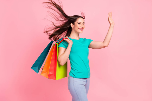 Profile side photo of young woman happy positive smile waving hand hello shopping buy isolated over pastel color background - Foto, afbeelding