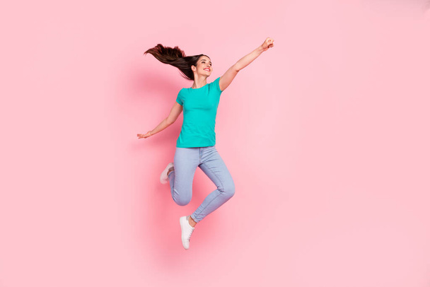 Full body profile side photo of young woman happy positive smile fly air jump superhero power isolated over pastel color background - Φωτογραφία, εικόνα