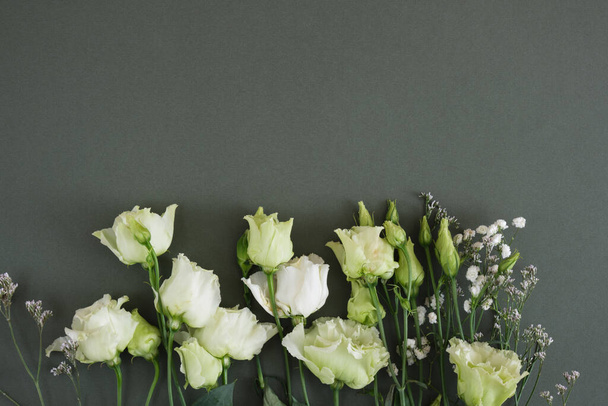 Lemon white and green roses on a dark green background, postcard, copy space, top view, mock up flat lay - Foto, imagen
