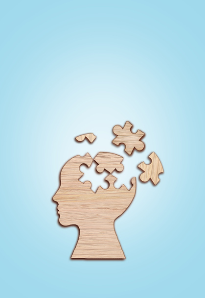 Die Silhouette des menschlichen Kopfes mit einem Puzzleteil auf blauem Hintergrund, Symbol für psychische Gesundheit. - Foto, Bild