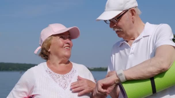 Elegante nonno americano mostra a sua nonna il suo orologio intelligente, - Filmati, video