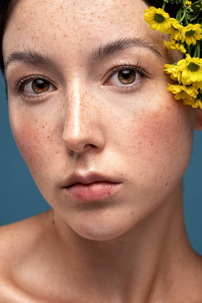 Beauty portrait of young swedish natural woman with freckles on face. Girl is looking at the camera. Closeup photo. Skin care concept.  - Фото, зображення