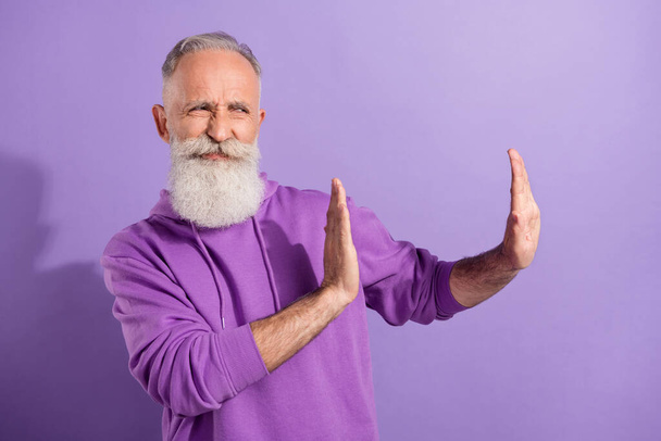 Portrait of elderly retired pensioner grey-haired man wear hoodie showing no sign disagree isolated over purple violet color background - Fotó, kép