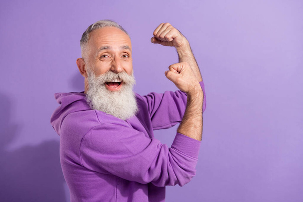 Profile side view portrait of attractive lucky cheerful grey-haired man celebrating great attainment isolated over purple violet color background - 写真・画像