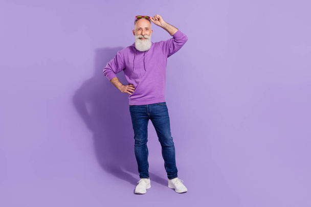 Full length body size view of attractive cheerful grey-haired man posing touching specs isolated over purple violet color background - Valokuva, kuva