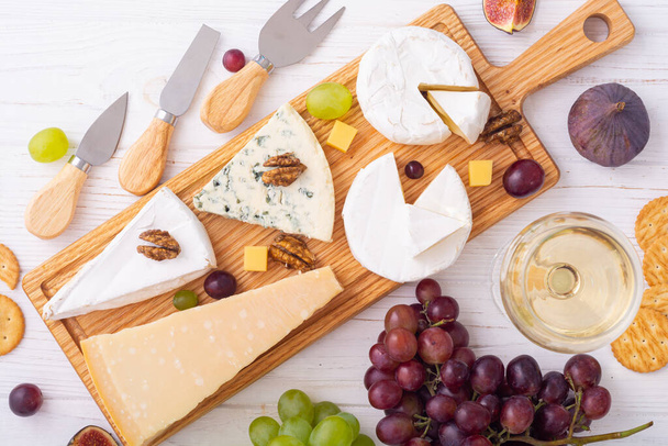 Cheese board with fruits and snack . delicatessen food background - Fotoğraf, Görsel