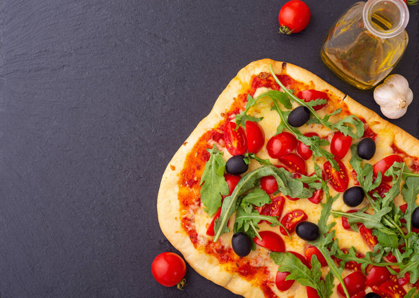 Traditional italian pizza with vegetables tomatoes cherry , olives and  arugula . Pinsa Romana - 写真・画像