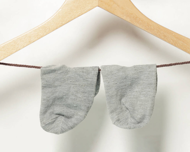 Plain gray socks for men and women. Socks are usually used to protect the feet from direct friction with shoes or sandals and also provide a warm feeling to the feet. Sock mockup. Focus blur. - Фото, изображение