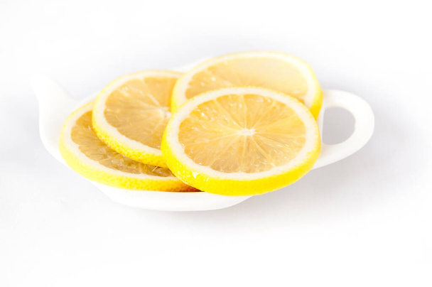 Lemon sliced lies on a plate shaped - Photo, image