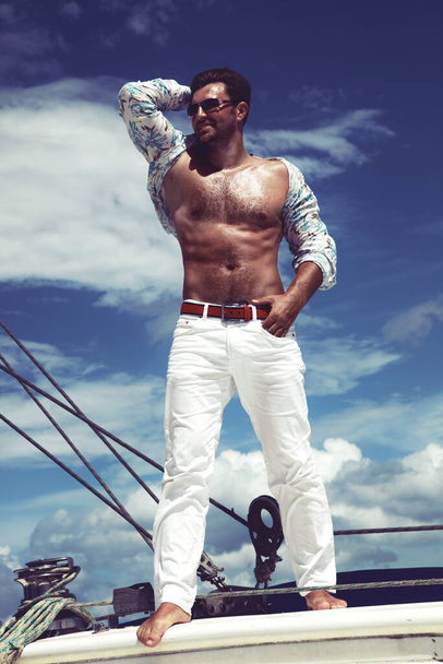 Man enjoying summer time holiday on sailing boat. - Photo, Image