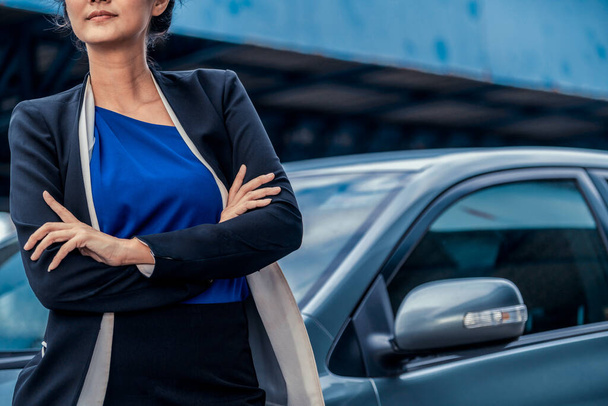 Уверенная деловая женщина, стоящая рядом с машиной. - Фото, изображение