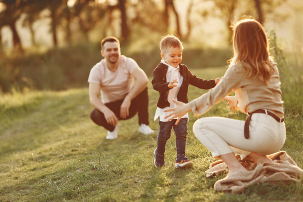 Cute family playing in a summer field - Foto, imagen