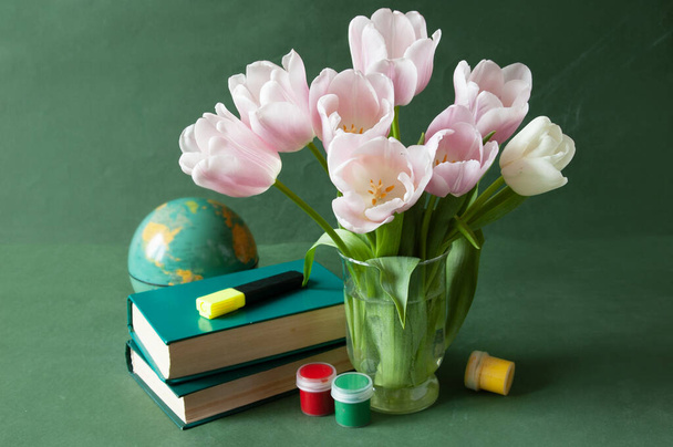 stack of books and a bouquet of flowers on artistic background. Teacher's Day. Still life - Фото, изображение