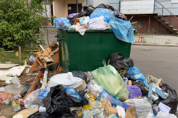 Trash bin overloaded, no garbage collection problem, outdoors - Photo, Image