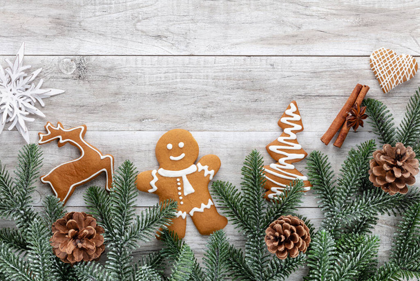 Tasty gingerbread cookies and Christmas decor on wooden background. - Foto, Imagen