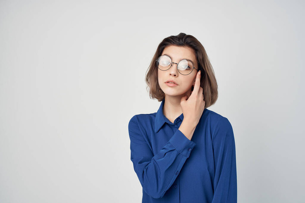 woman in blue shirt wearing glasses elegant style self-confidence studio - Fotó, kép