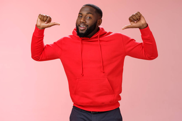 Proud confident arrogant good-looking african american bearded male coworker in red hoodie raise thumbs pointing himself bragging look cheeky talking accomplishments himself, standing pink wall - Photo, Image