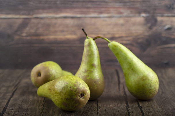Fresh ripe delicious green pears on wooden background. High quality photo - Photo, Image