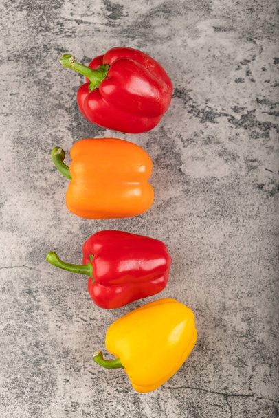 Set of healthy ripe bell peppers on stone background. High quality photo - Zdjęcie, obraz
