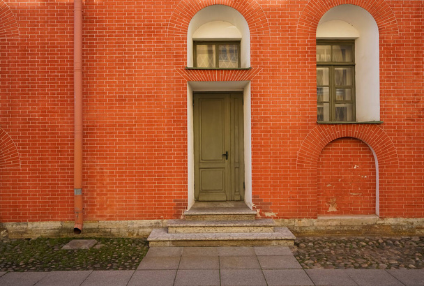 Colorful brick wall and doors in Saint Petersburg, Russia. Historic green doors. Peter-Pavel's Fortress. - 写真・画像
