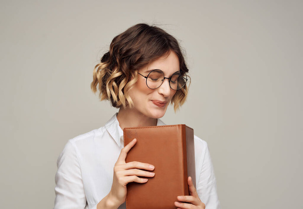 pretty woman in glasses with book elegant style for professionals Studio - Foto, afbeelding
