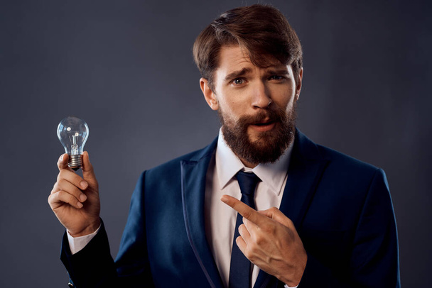 bearded man in a suit with a lamp in his hand - Photo, image