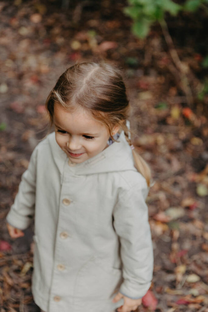 girl dressed in stylish autumn clothes posing for a photo on a walk in the park  - Photo, image