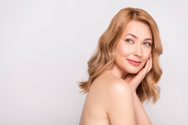 Photo portrait woman naked shoulders touching face in salon isolated white color background copyspace - Photo, Image