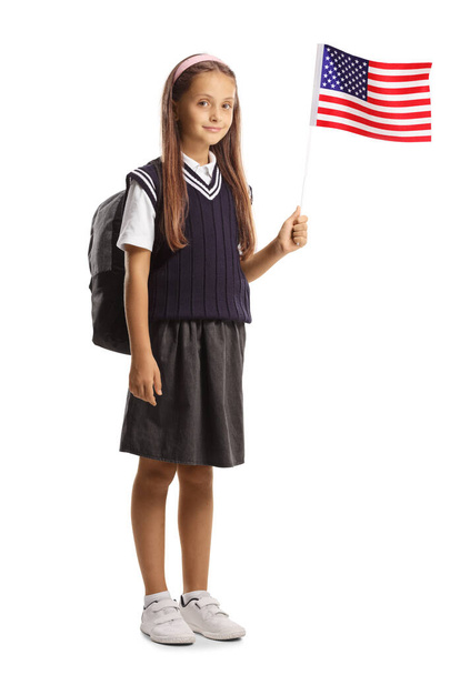 Full length portrait of a schoolgirl waving a small US flag isolated on white background - Photo, image