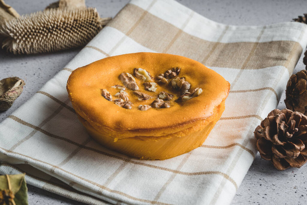 Sweet potato cake with walnuts decorated with dry leaves - Fotó, kép