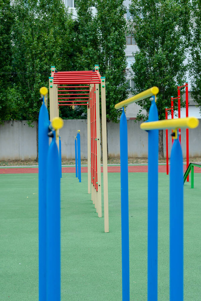 Sports ground with a variety of horizontal bars. Open area for sports in the city park. Horizontal and vertical bars. Sports, active lifestyles. No people. Selective focus. - Photo, Image