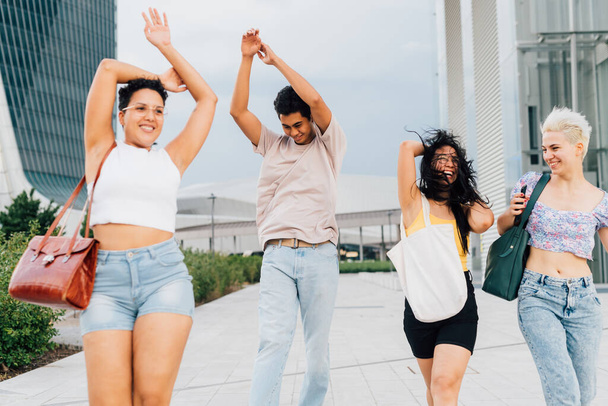 多民族の友人のグループ屋外のダンスを一緒に楽しみを持っている結合自由を感じる - 写真・画像