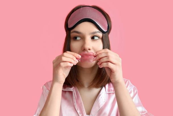 Young woman with lip mask on color background - Photo, Image