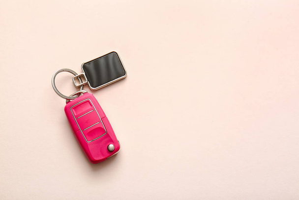 Car key with stylish keychain on light background - Photo, Image